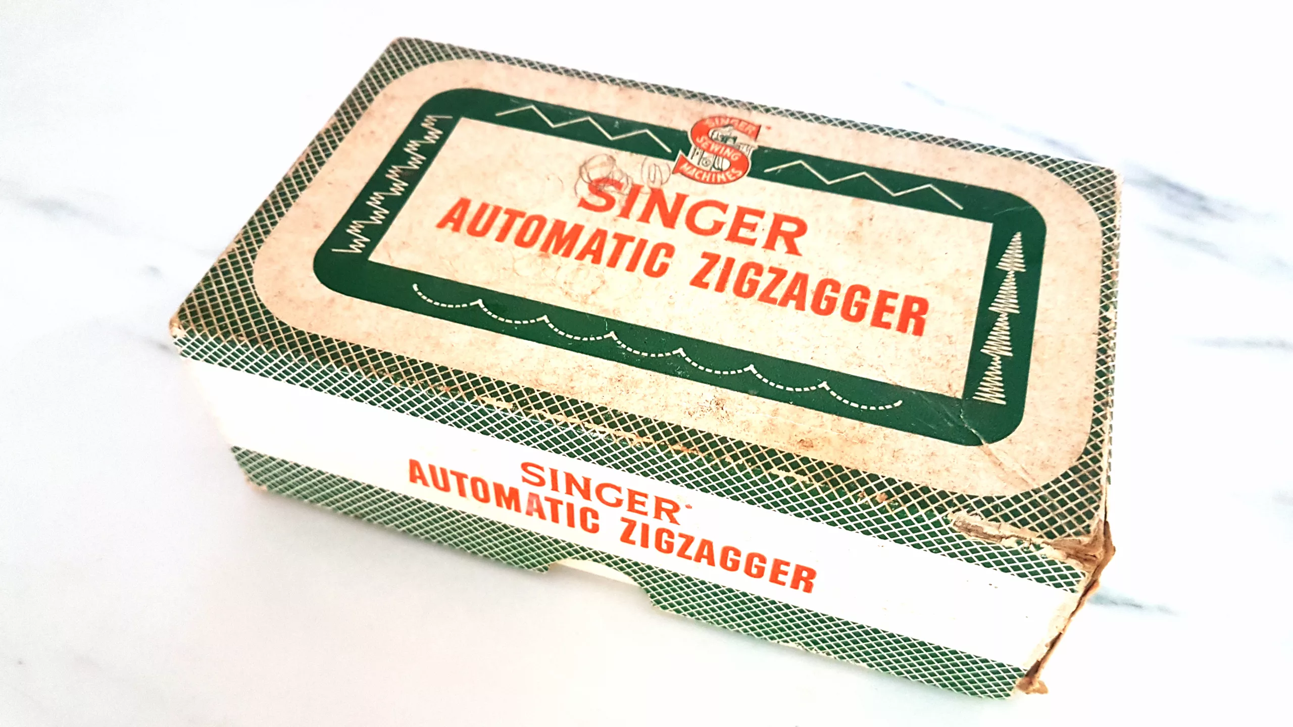 Box containing a Singer Automatic Zigzagger vintage attachment